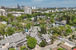 Aerial perspective showcasing a residential development with multiple units, each featuring a pitched shingle roof - 