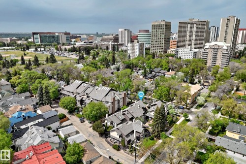 Aerial perspective showcasing residential properties with a backdrop of urban structures and green spaces - 7930 111 Street, Edmonton, AB - Outdoor With View