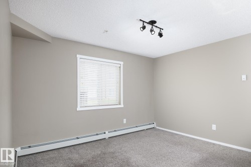 Neutral-toned walls and plush gray carpeting - 102 25 Element Dr, St. Albert, AB 