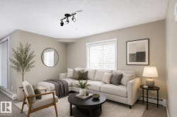 Living area featuring neutral wall tones, track lighting, and a large window with blinds - 