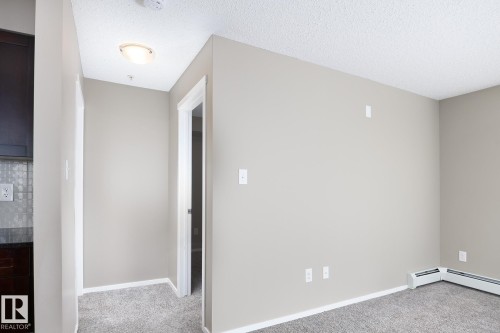 Carpeted flooring throughout, neutral wall paint, and white trim - 102 25 Element Dr, St. Albert, AB 