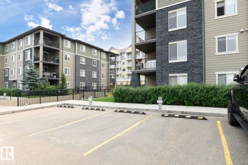 Multi-story residential buildings featuring contemporary siding and dark stone facade accents - 102 25 Element Dr, St. Albert, AB 