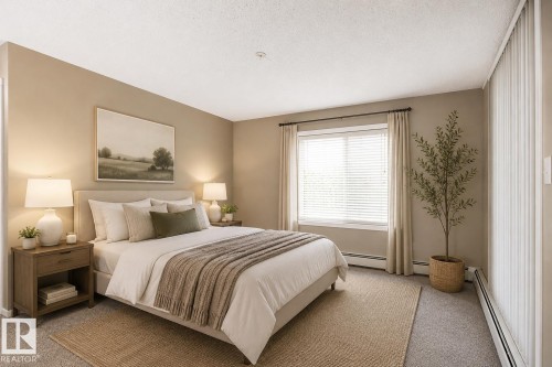 Carpeted bedroom featuring a large window with blinds and curtains - 102 25 Element Dr, St. Albert, AB 