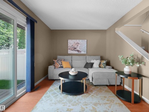 Living area with wood-finish flooring and a textured area rug - 16 13833 30 Street, Edmonton, AB 