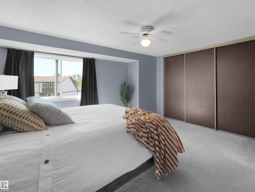 Sliding panel closet doors with a light gray carpeted floor - 16 13833 30 Street, Edmonton, AB 
