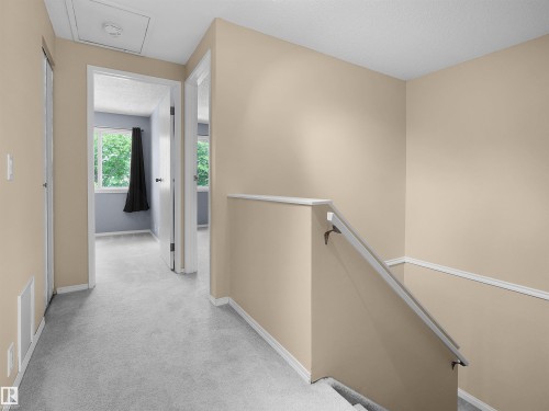 Carpeted hallway with painted walls and white trim - 16 13833 30 Street, Edmonton, AB 
