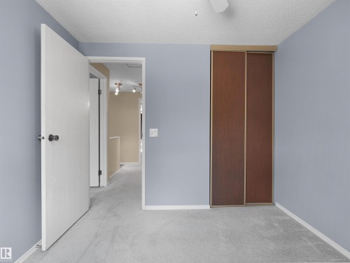 Room featuring light blue walls and gray carpet flooring - 16 13833 30 Street, Edmonton, AB 