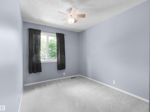 Light gray wall paint complemented by white trim and light gray carpet flooring - 16 13833 30 Street, Edmonton, AB 