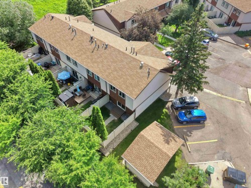 Multi-unit residential structure featuring a brown shingle roof and light-colored siding - 16 13833 30 Street, Edmonton, AB 