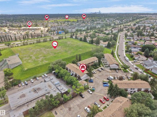 Aerial perspective showcasing multiple residential buildings, expansive green spaces, and a detailed road network - 16 13833 30 Street, Edmonton, AB 