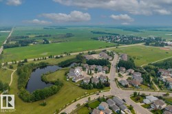 Aerial view showcasing the property's lakeside position within a residential community - 