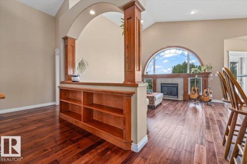 Arched architectural feature with integrated built-in shelving defining an open living space - 215 Westerra Point(E), Stony Plain, AB 