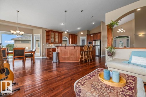 Open concept living space featuring wood-finish flooring throughout the main level - 215 Westerra Point(E), Stony Plain, AB 