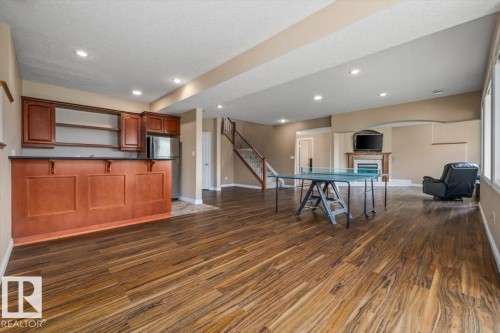 Spacious open-concept lower level featuring wood-finish flooring throughout - 215 Westerra Point(E), Stony Plain, AB 