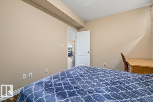 Bedroom featuring wood-finish flooring and neutral wall tones - 215 Westerra Point(E), Stony Plain, AB 