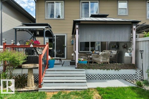 Backyard deck featuring a covered gazebo, privacy screen, and direct access to the interior - 6042 214 Street, Edmonton, AB - Outdoor With Deck Patio Veranda With Exterior