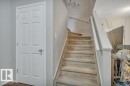 Carpeted staircase with white balusters and handrails - 6042 214 Street, Edmonton, AB  - Indoor Photo Showing Other Room 