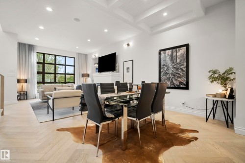 Open-concept living and dining area featuring herringbone wood-finish flooring, a coffered ceiling, and recessed lighting - 6115 111 Avenue, Edmonton, AB - Indoor Photo Showing Dining Room