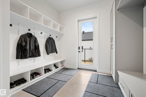 Entryway featuring a built-in storage bench with cubbies, upper shelving units, and wall-mounted coat hooks - 6115 111 Avenue, Edmonton, AB - Indoor