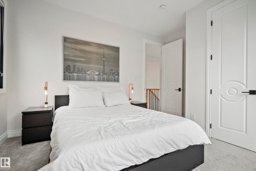 Neutral-toned carpeting extends throughout the room, complemented by white walls and trim - 6115 111 Avenue, Edmonton, AB - Indoor Photo Showing Bedroom