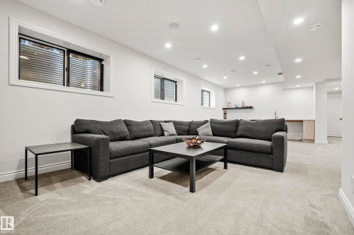 Spacious lower-level area featuring light-toned carpeting, ample recessed lighting, and white walls - 6115 111 Avenue, Edmonton, AB - Indoor Photo Showing Living Room