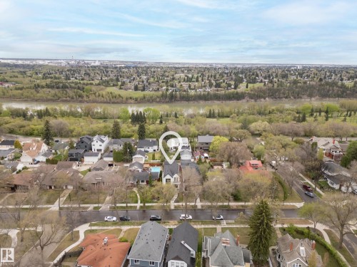 Aerial perspective featuring a residential neighborhood with a river and expansive green space in the background - 6115 111 Avenue, Edmonton, AB - Outdoor With View