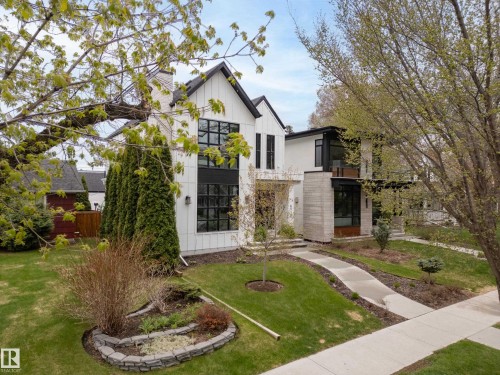 Contemporary architecture featuring vertical white siding and dark trim - 6115 111 Avenue, Edmonton, AB - Outdoor