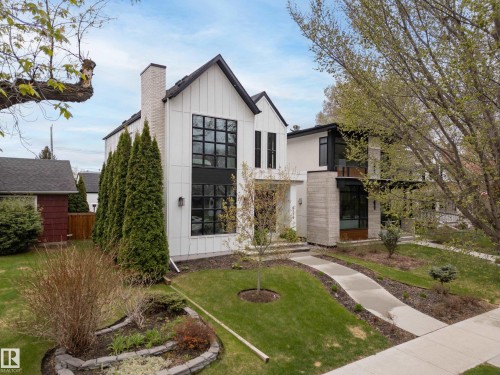 Modern architectural style featuring white vertical siding and black-framed windows - 6115 111 Avenue, Edmonton, AB - Outdoor