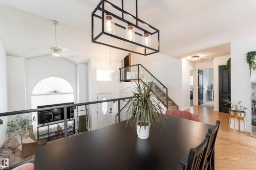 Open-concept living space with a vaulted ceiling and an arched window - 183 Dechene Road, Edmonton, AB 