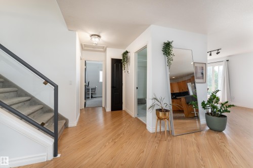 Light wood-finish flooring throughout the main level - 183 Dechene Road, Edmonton, AB 
