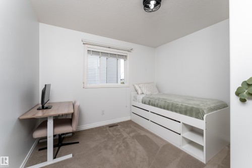 Room featuring light gray walls, plush carpet flooring, and a single window with blinds - 183 Dechene Road, Edmonton, AB 