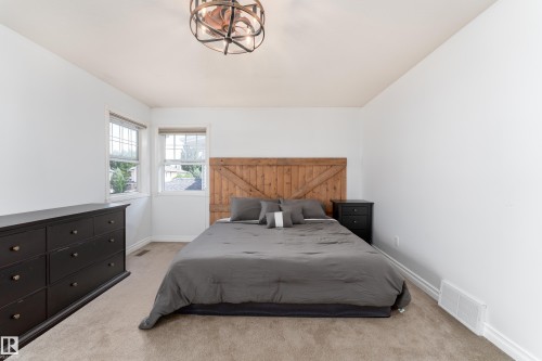 Light-filled room featuring neutral wall tones and a textured carpet - 183 Dechene Road, Edmonton, AB 