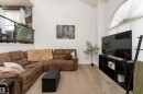 Vaulted ceiling living area featuring light-toned carpet flooring and white painted walls - 183 Dechene Road, Edmonton, AB 