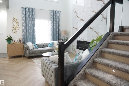 Modern interior featuring wood-finish flooring in a herringbone pattern - 17703 74 Street, Edmonton, AB 