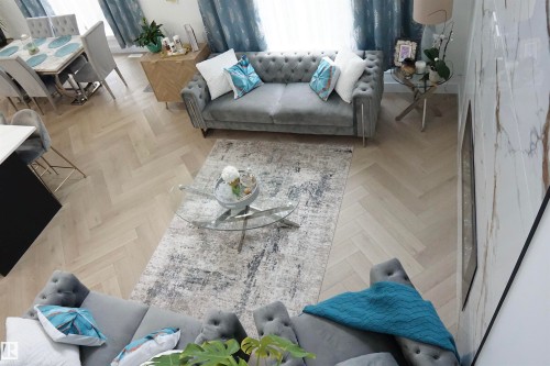 Herringbone wood-finish flooring extending throughout the open-concept living area - 17703 74 Street, Edmonton, AB 