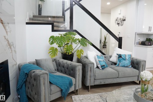 Modern staircase featuring glass panel railings and dark wood treads - 17703 74 Street, Edmonton, AB 