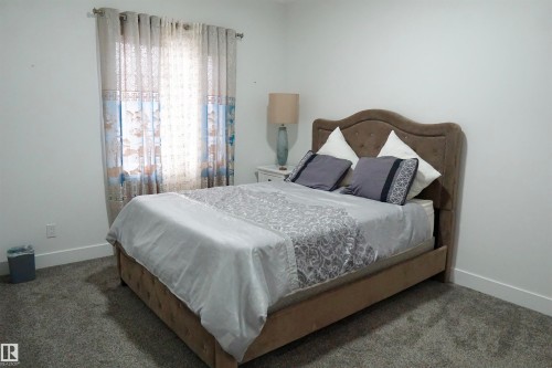 Neutral wall color, carpeted flooring, and a single window with curtain rod - 17703 74 Street, Edmonton, AB 