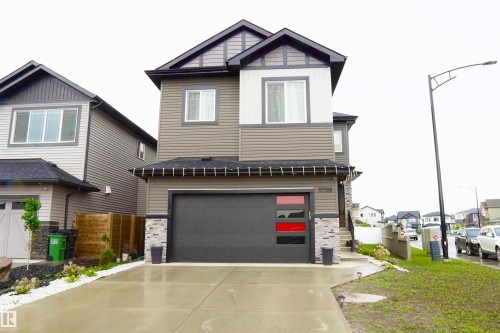 Modern exterior featuring multi-toned siding, stone accents, and a contrasting roofline - 17703 74 Street, Edmonton, AB 