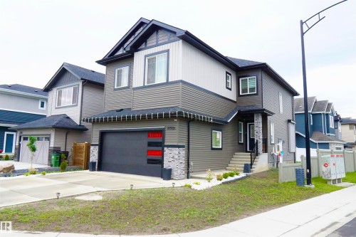 Contemporary two-story residence featuring multi-tone siding and stone accents - 17703 74 Street, Edmonton, AB 