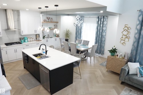 Open-concept living space with herringbone wood-finish flooring - 17703 74 Street, Edmonton, AB 