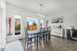 Dining area with dark wood-finish flooring and white walls - 