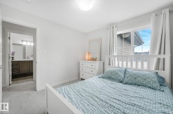 Bedroom featuring light gray carpeting and white walls - 