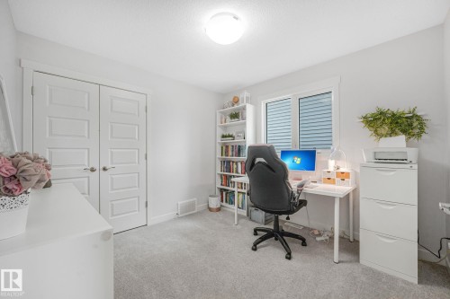 Bright interior room featuring light gray carpeting and white walls - 556 Merlin Landing Landing, Edmonton, AB 