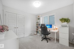 Bright interior room featuring light gray carpeting and white walls - 