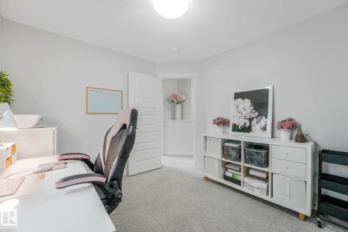 Bright room featuring light gray wall paint and matching gray carpet flooring - 556 Merlin Landing Landing, Edmonton, AB 