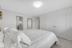 Bedroom featuring white walls, light gray carpet flooring, and a flush mount ceiling light - 
