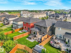 Aerial perspective highlighting multiple residences with dark shingle roofs, private backyards, and wood fencing - 