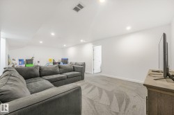 Spacious room with recessed lighting and neutral wall tones - 