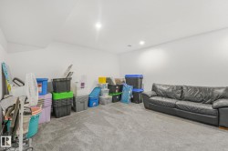 Carpeted room with recessed lighting and a neutral color palette - 