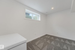 Substantial room featuring a window, recessed lighting, and patterned grey carpeting - 